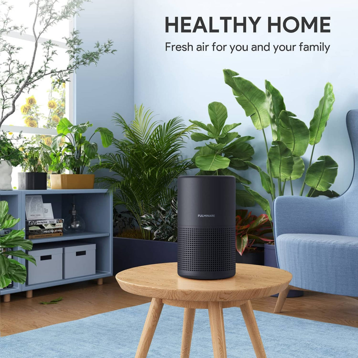 Black air purifier cylinder on a wooden table, front perforation grille visible