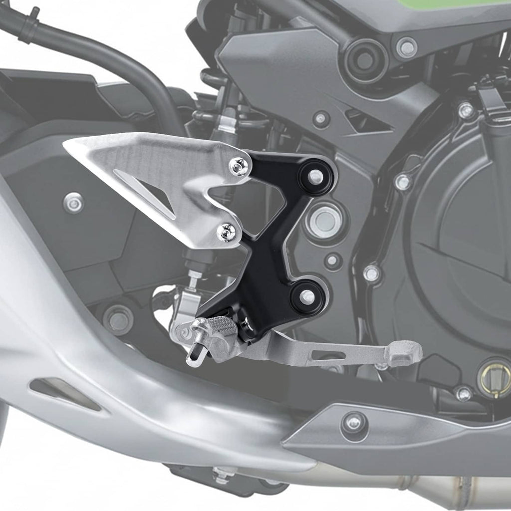 Close-up of installed motorcycle foot peg bracket with silver plate and black frame