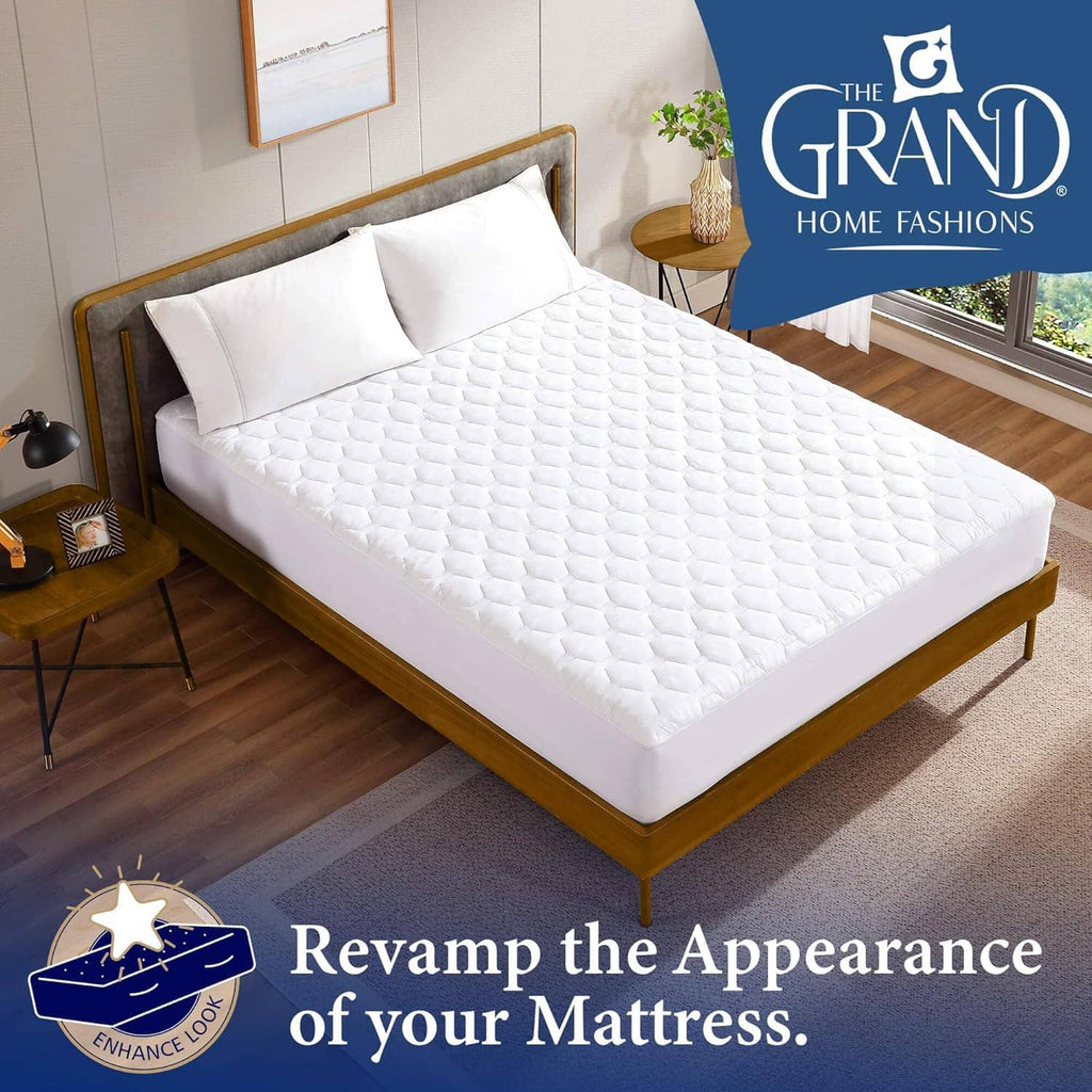 White quilted mattress pad on queen bed with fitted edges over the mattress
