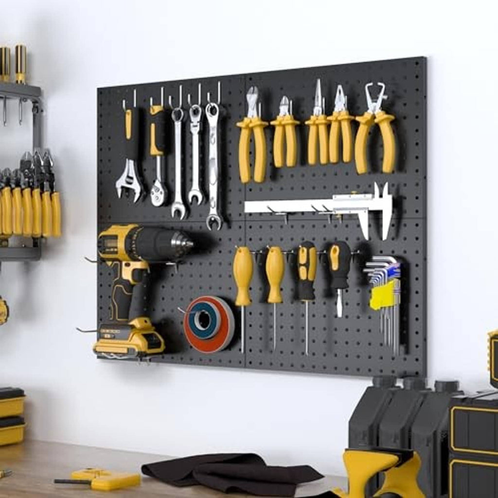 Black metal pegboard wall organizer with hanging hand tools and wrenches on hooks