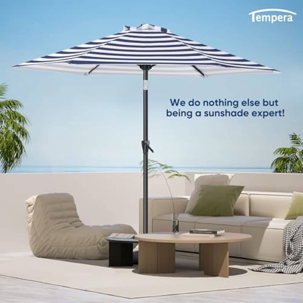 Blue-and-white striped beach umbrella standing open with central support pole